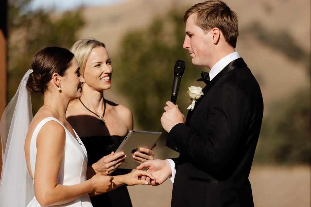 Groom-and-bride-under-wedding-arches